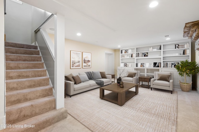 carpeted living room with built in shelves