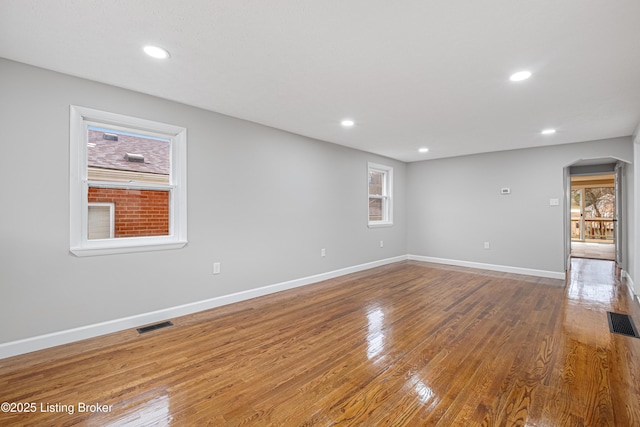 unfurnished room with hardwood / wood-style flooring