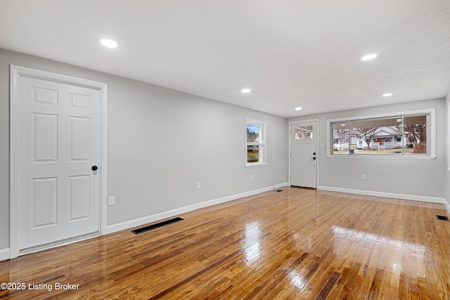 unfurnished room with hardwood / wood-style flooring