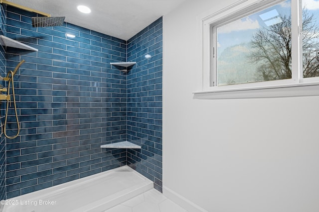 bathroom with a tile shower