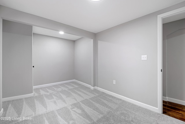 basement featuring light carpet