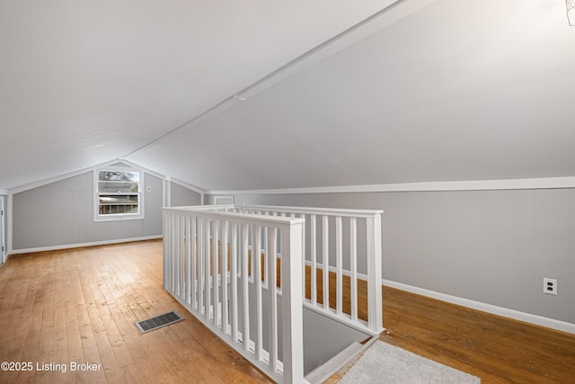 bonus room with vaulted ceiling and hardwood / wood-style floors