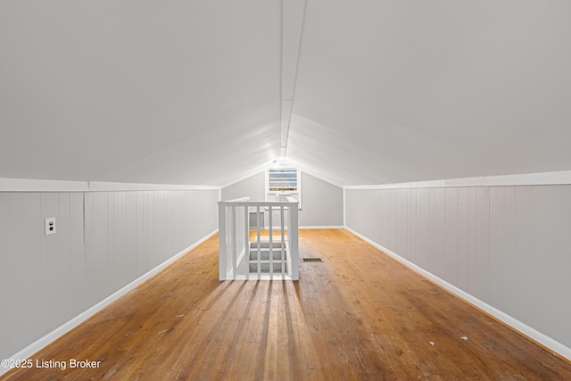 bonus room featuring lofted ceiling and light wood-type flooring