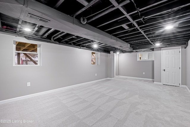 basement with light carpet and a healthy amount of sunlight