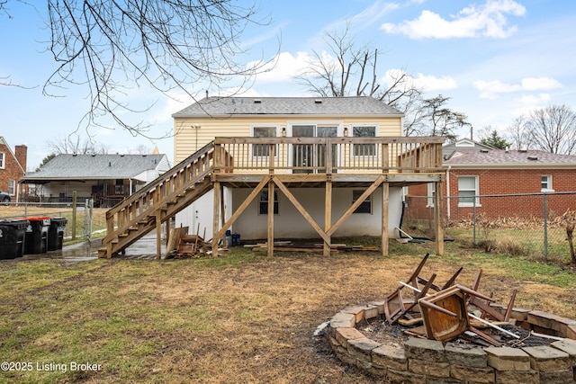 rear view of property featuring a wooden deck and a yard