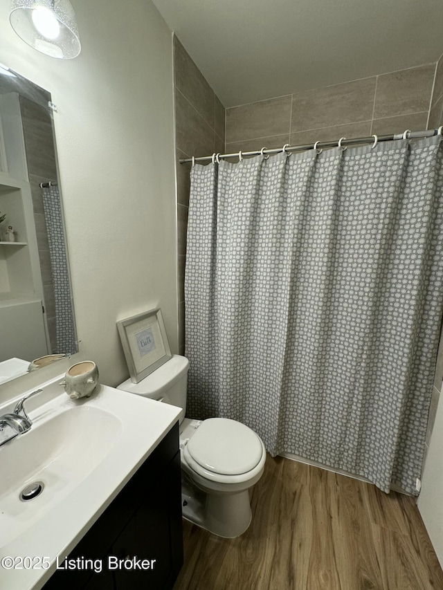 bathroom with a shower with curtain, vanity, hardwood / wood-style floors, and toilet