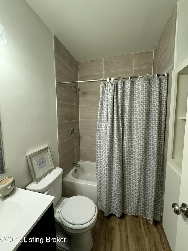 full bathroom featuring hardwood / wood-style flooring, vanity, toilet, and shower / bath combo