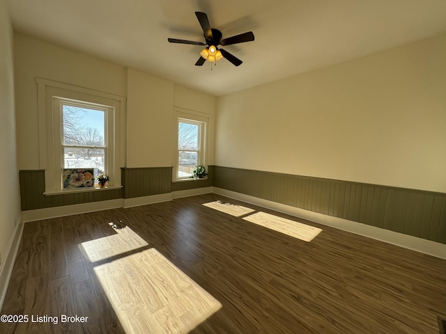 unfurnished room with dark wood-type flooring and ceiling fan