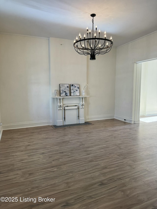 unfurnished dining area featuring dark wood-type flooring and a chandelier