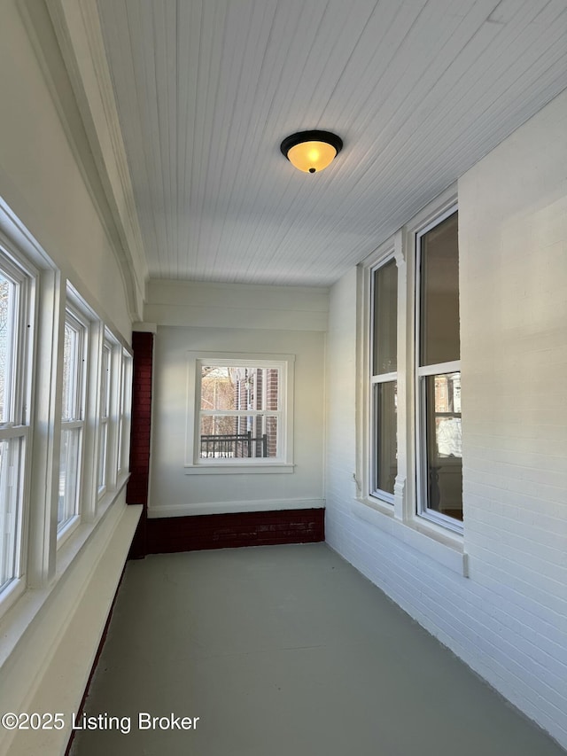 unfurnished sunroom featuring wooden ceiling