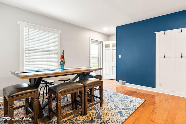 dining space with hardwood / wood-style floors