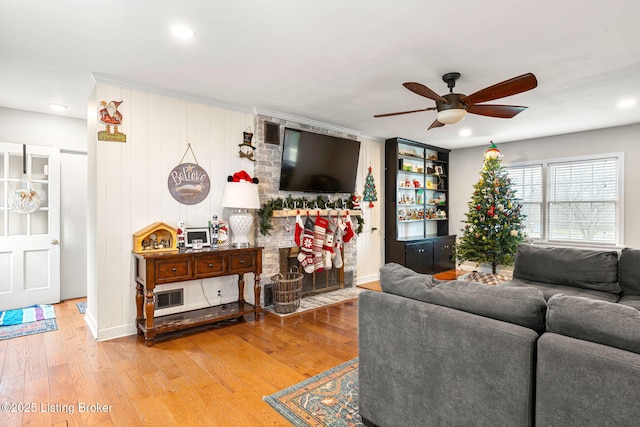 living room with ceiling fan and hardwood / wood-style floors