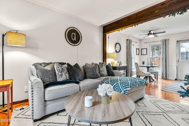 living room with ceiling fan and light hardwood / wood-style flooring