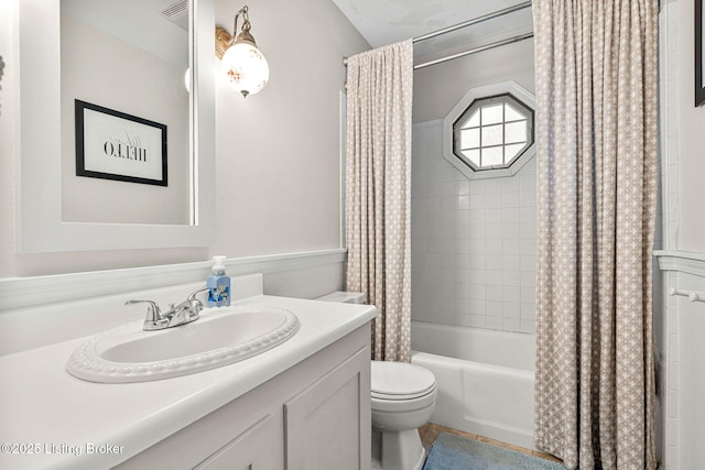 full bathroom with shower / tub combo with curtain, vanity, and toilet