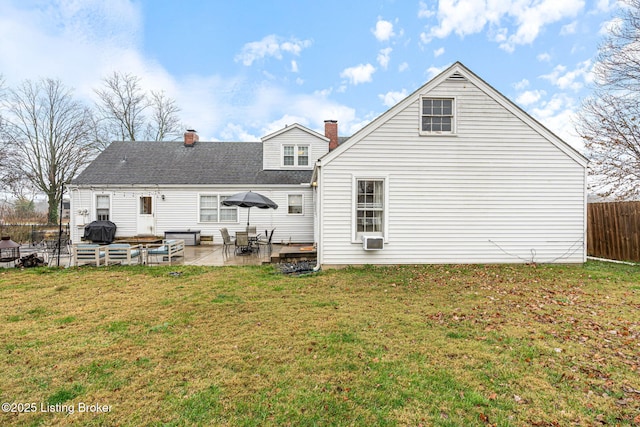 back of property featuring a patio and a lawn