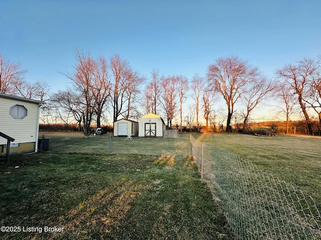 yard at dusk with a storage shed