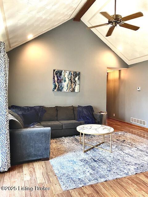 living room with vaulted ceiling with beams, wood-type flooring, and ceiling fan