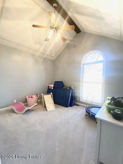 additional living space with light carpet, lofted ceiling with beams, and ceiling fan