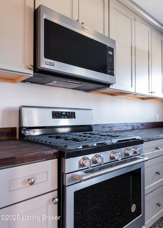 kitchen with appliances with stainless steel finishes and butcher block countertops