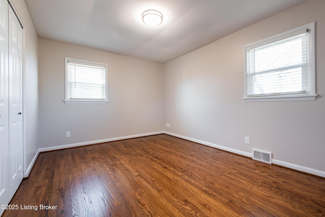 spare room with dark hardwood / wood-style floors