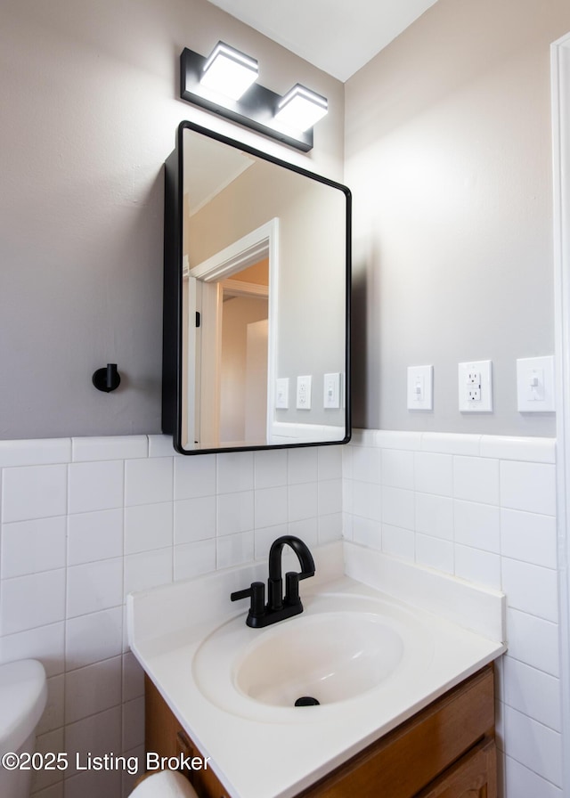 bathroom featuring vanity, tile walls, decorative backsplash, and toilet