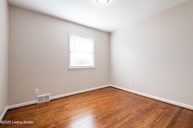 spare room with hardwood / wood-style flooring