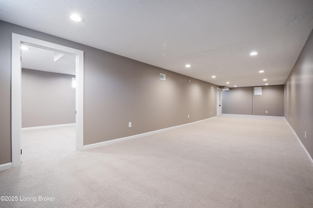 basement featuring light carpet