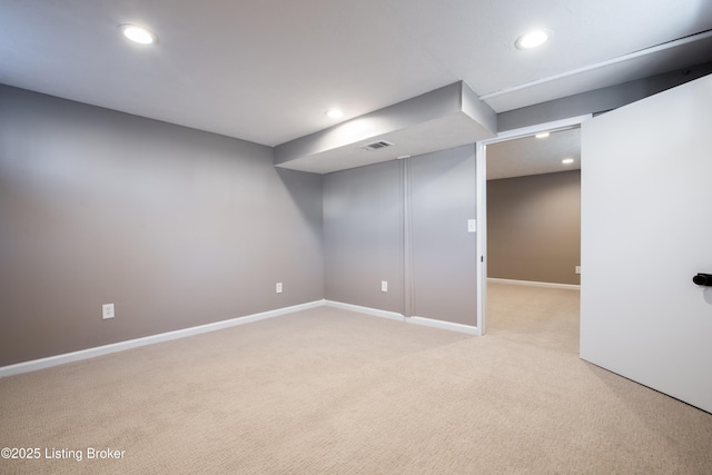 basement featuring light carpet