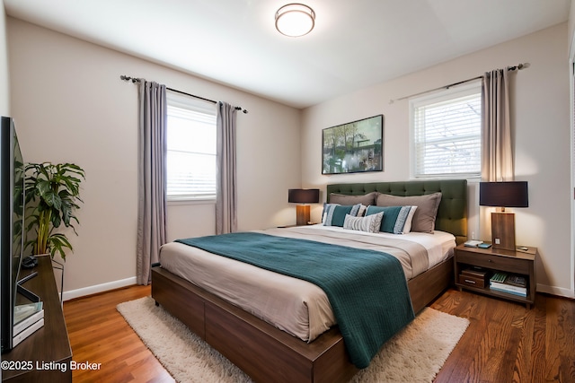 bedroom with dark hardwood / wood-style flooring