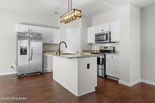 kitchen with a center island with sink, light stone counters, dark wood-style flooring, stainless steel appliances, and a sink