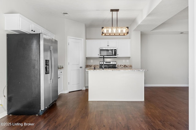 kitchen featuring stainless steel appliances, white cabinets, dark wood finished floors, and light stone counters