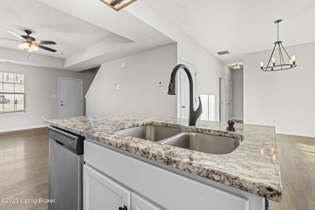 kitchen featuring a sink, visible vents, hanging light fixtures, stainless steel dishwasher, and a raised ceiling