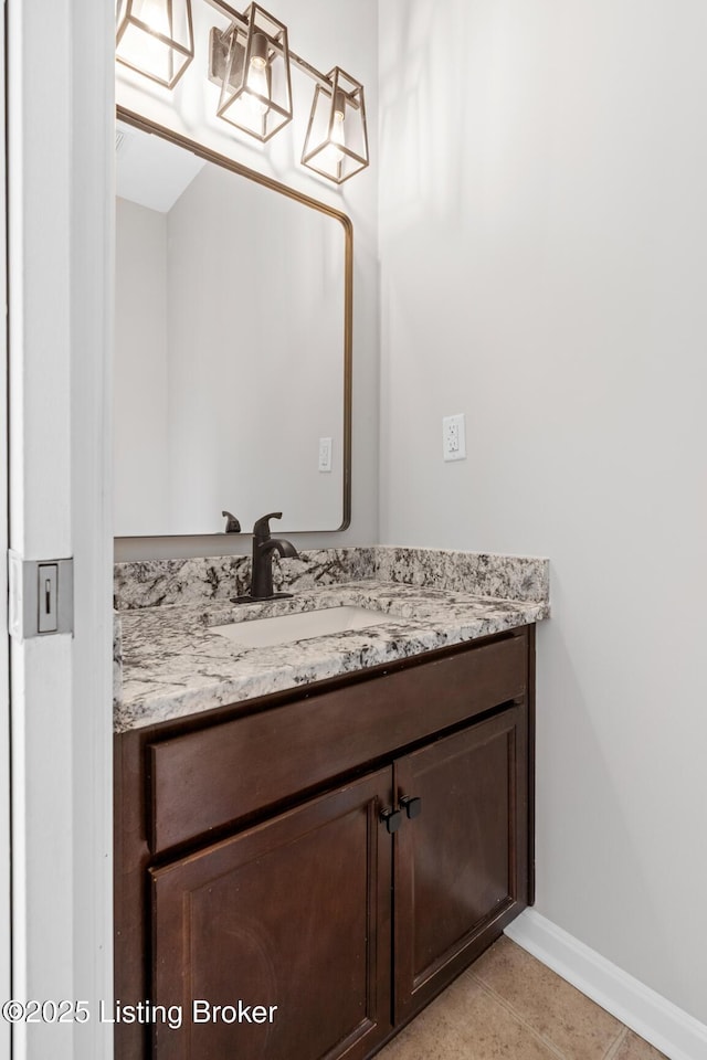 bathroom featuring vanity, baseboards, and tile patterned floors