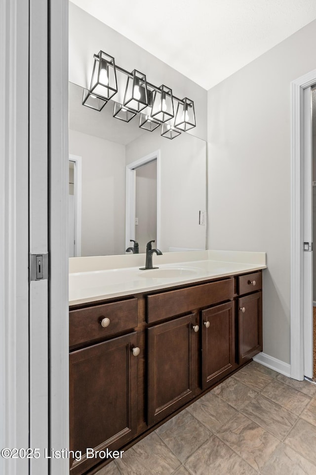 bathroom with vanity and baseboards