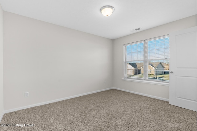 unfurnished room with baseboards, visible vents, and carpet flooring