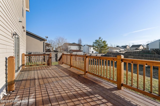 deck with a residential view and a fenced backyard