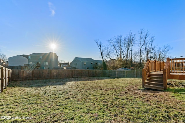 view of yard with a deck and a fenced backyard