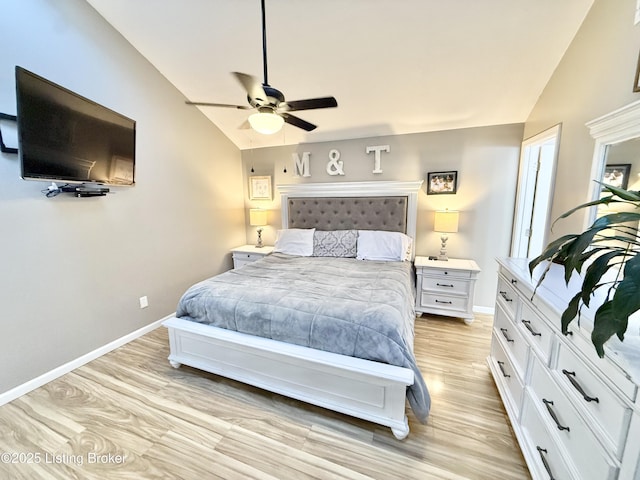 bedroom with vaulted ceiling, ceiling fan, and light wood-type flooring