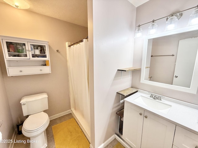 bathroom featuring vanity, toilet, and curtained shower