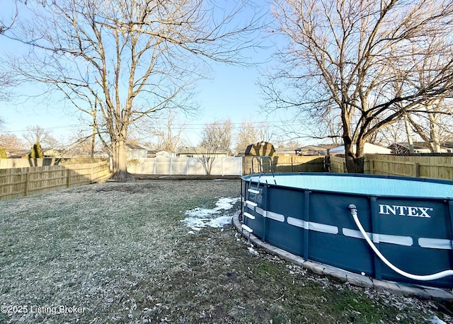 view of yard with a fenced in pool