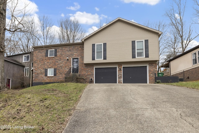 split foyer home featuring a garage and a front yard