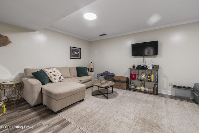 living room featuring hardwood / wood-style flooring and ornamental molding