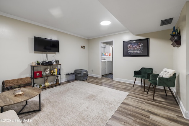 living room featuring crown molding and wood-type flooring