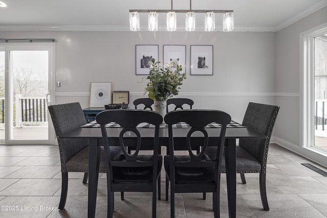 dining room with crown molding and plenty of natural light