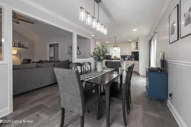 dining area featuring crown molding, vaulted ceiling, dark hardwood / wood-style floors, and ceiling fan