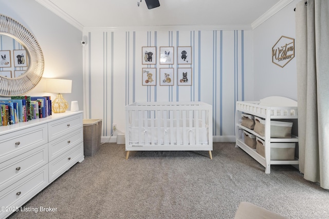 carpeted bedroom with crown molding and a nursery area