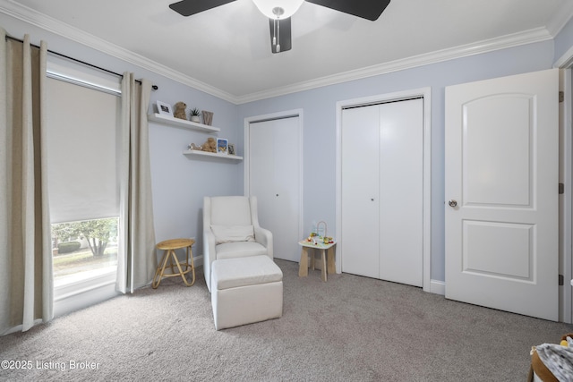 sitting room featuring ornamental molding, light colored carpet, and ceiling fan