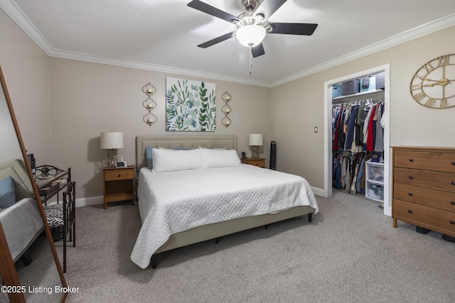 carpeted bedroom featuring crown molding, ceiling fan, a spacious closet, and a closet