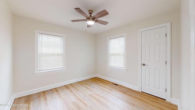 spare room with ceiling fan and light wood-type flooring