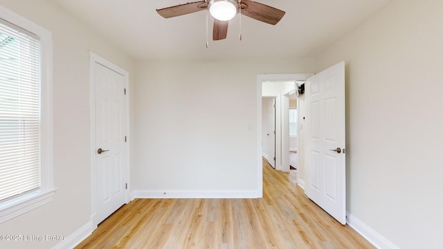 unfurnished bedroom with ceiling fan and light hardwood / wood-style floors